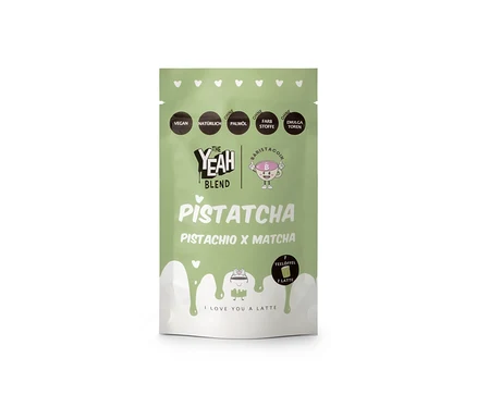 Eine hellgrüne Standbodenverpackung von The Yeah Blend - Pistatcha Matcha - 100 g. Die Packung zeigt Texte, die darauf hinweisen, dass sie vegan, natürlich und frei von Palmöl, Farbstoffen und Emulgatoren ist, zusammen mit einem 'Baristacoin'-Logo und einer Latte-Grafik mit dem Text 'I LOVE YOU A LATTE'.